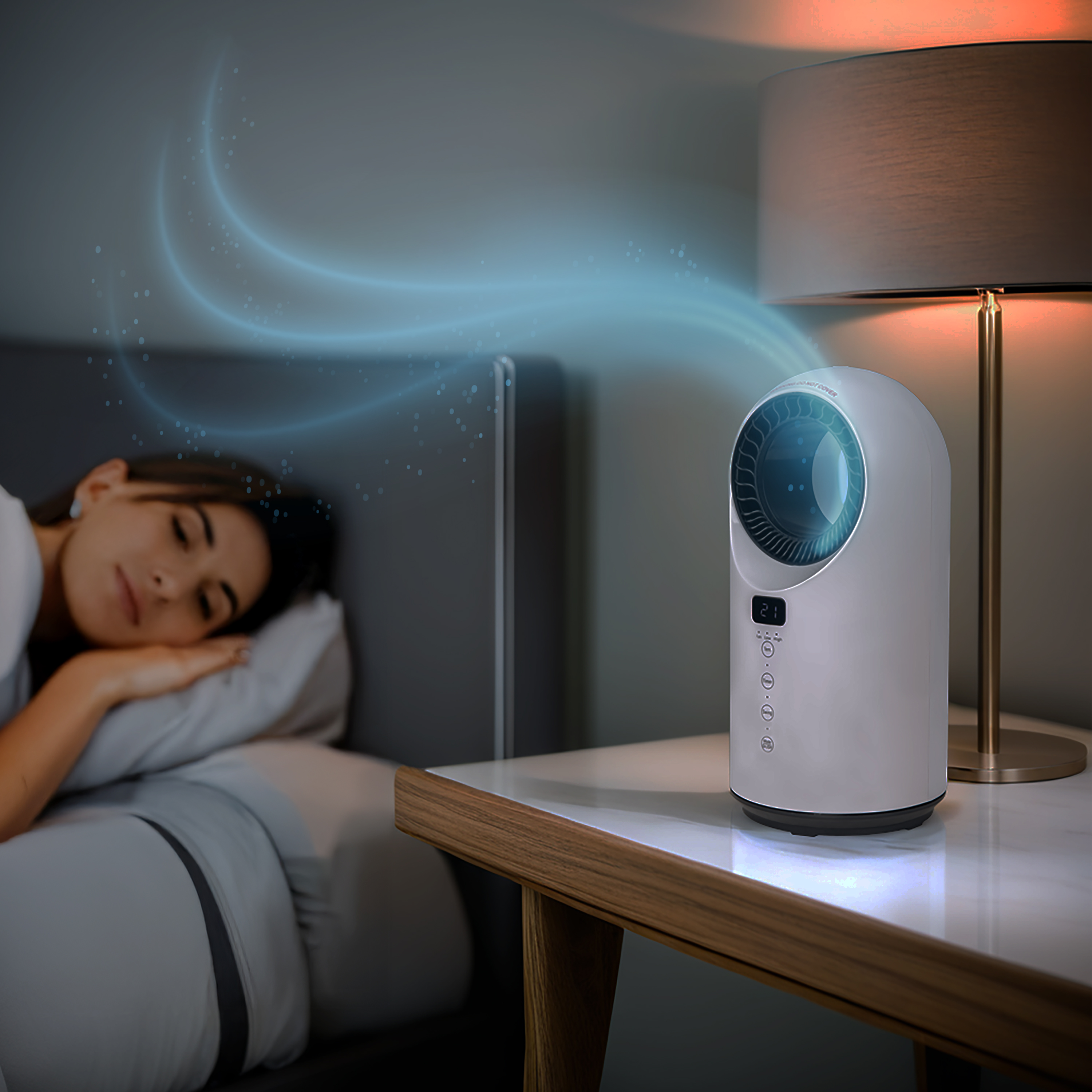 a woman sleeping in bed with a lamp and a round device